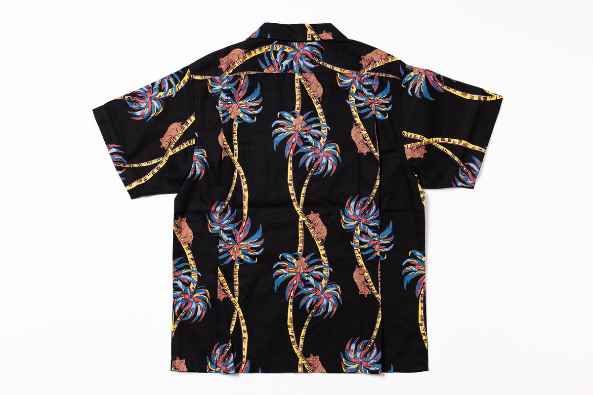 Black shirt with colorful palm tree pattern on a white background