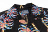Black shirt with colorful palm tree design and Studio Doritos label.