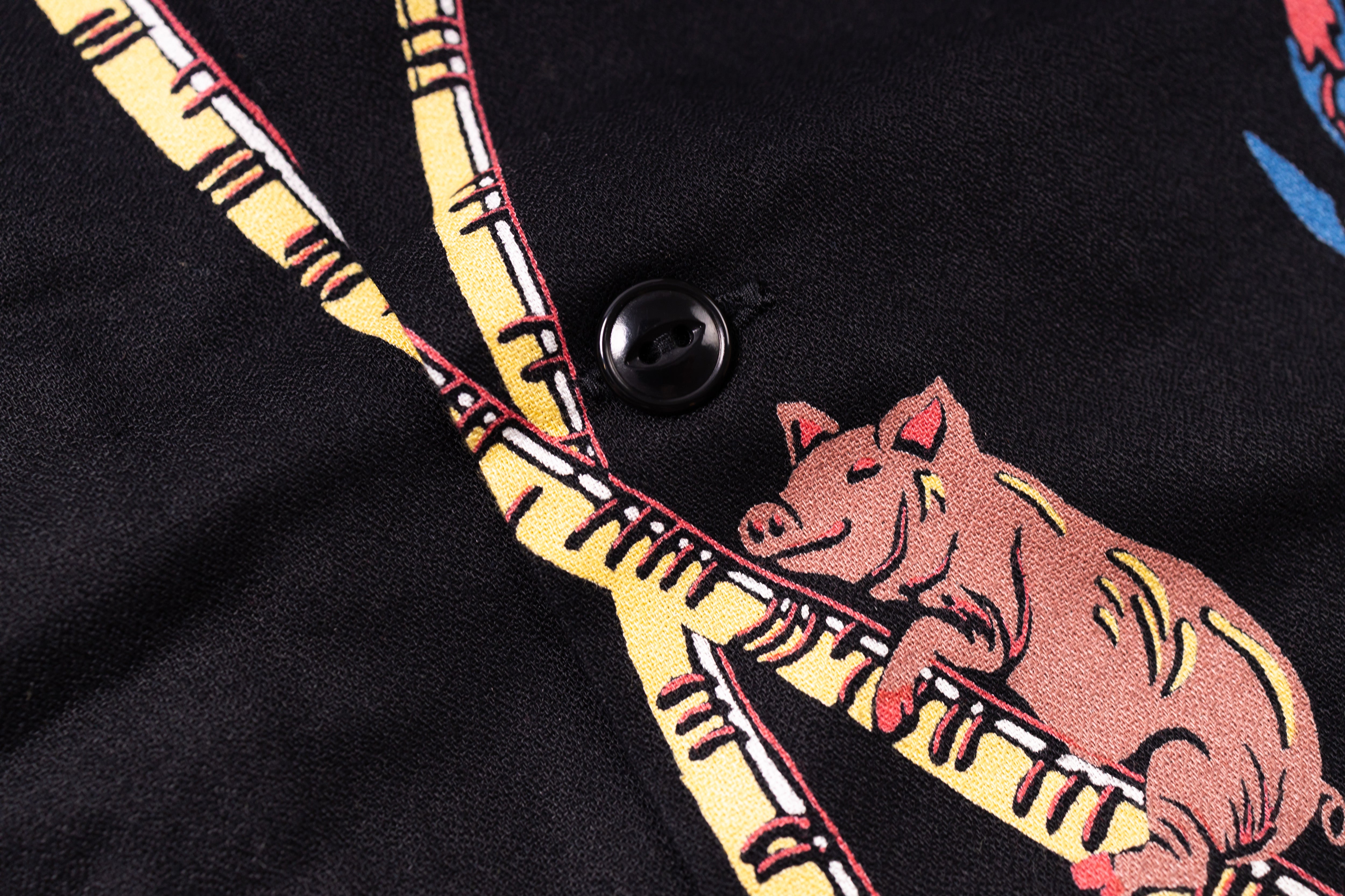 Embroidered pig design on a black fabric background