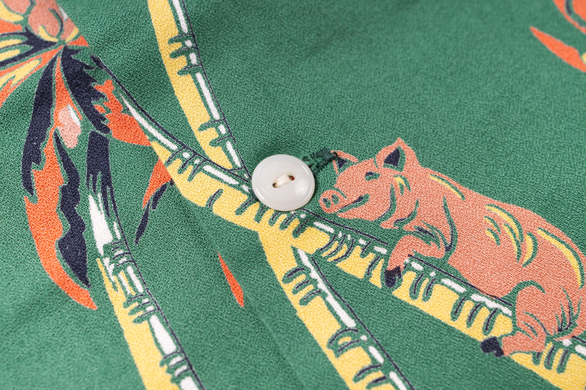 Close-up of a shirt with pig and bamboo design on a green background