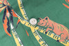 Close-up of a shirt with pig and bamboo design on a green background