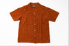 A short-sleeve button-up shirt in rust orange corduroy, laid flat against a white background.
