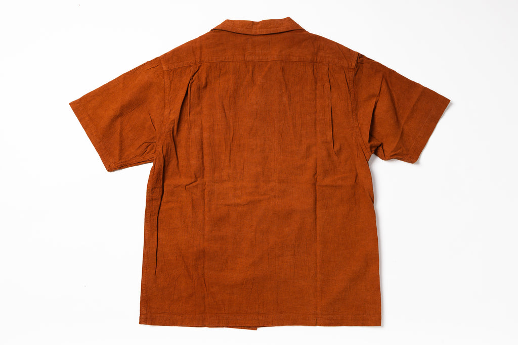 A short-sleeve button-up shirt in a rust orange color, shown from the back against a plain white background.
