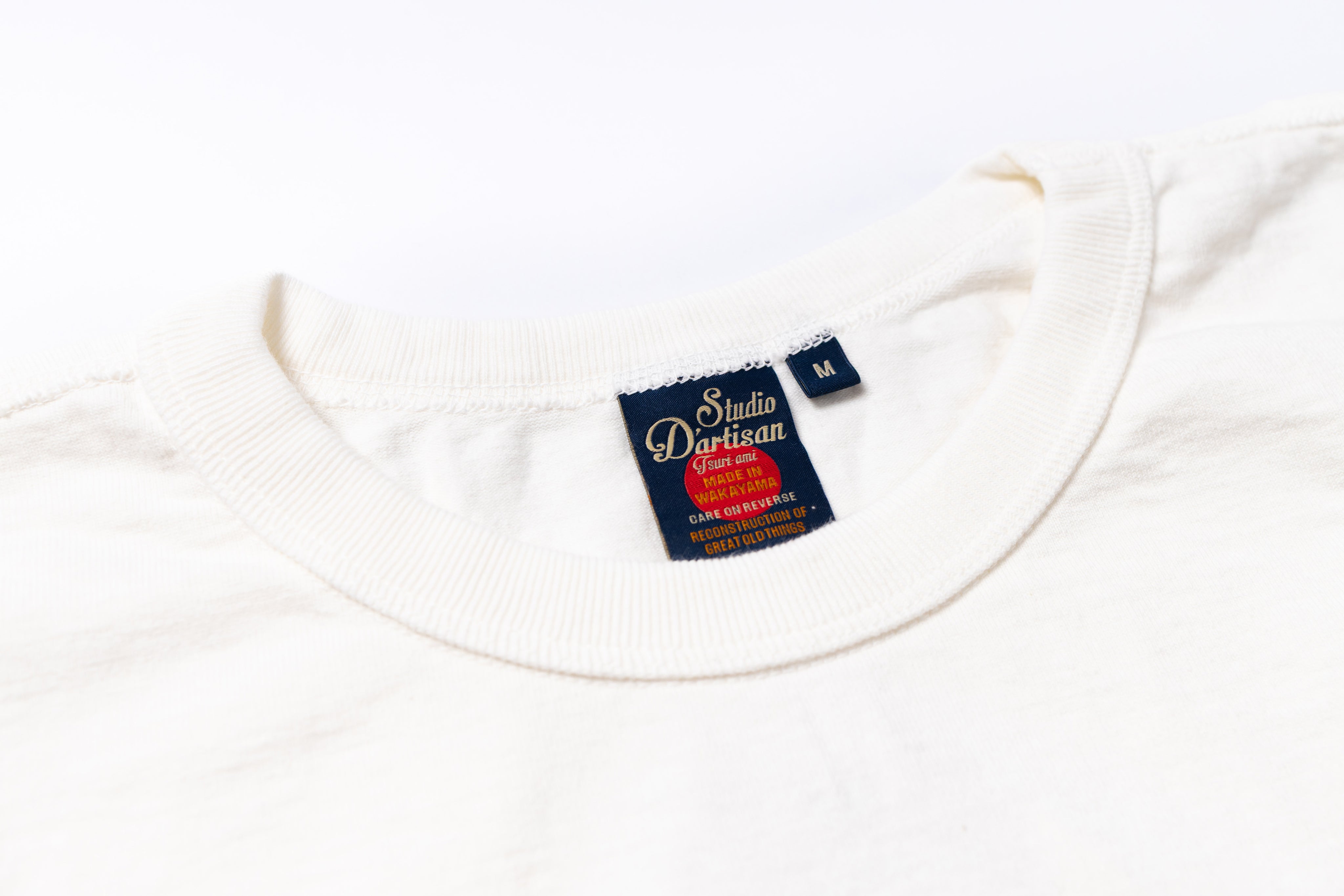 White shirt with a visible label on a white background