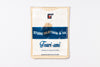 Packaged t-shirt with 'Studio Artisan & Co' branding on a white background
