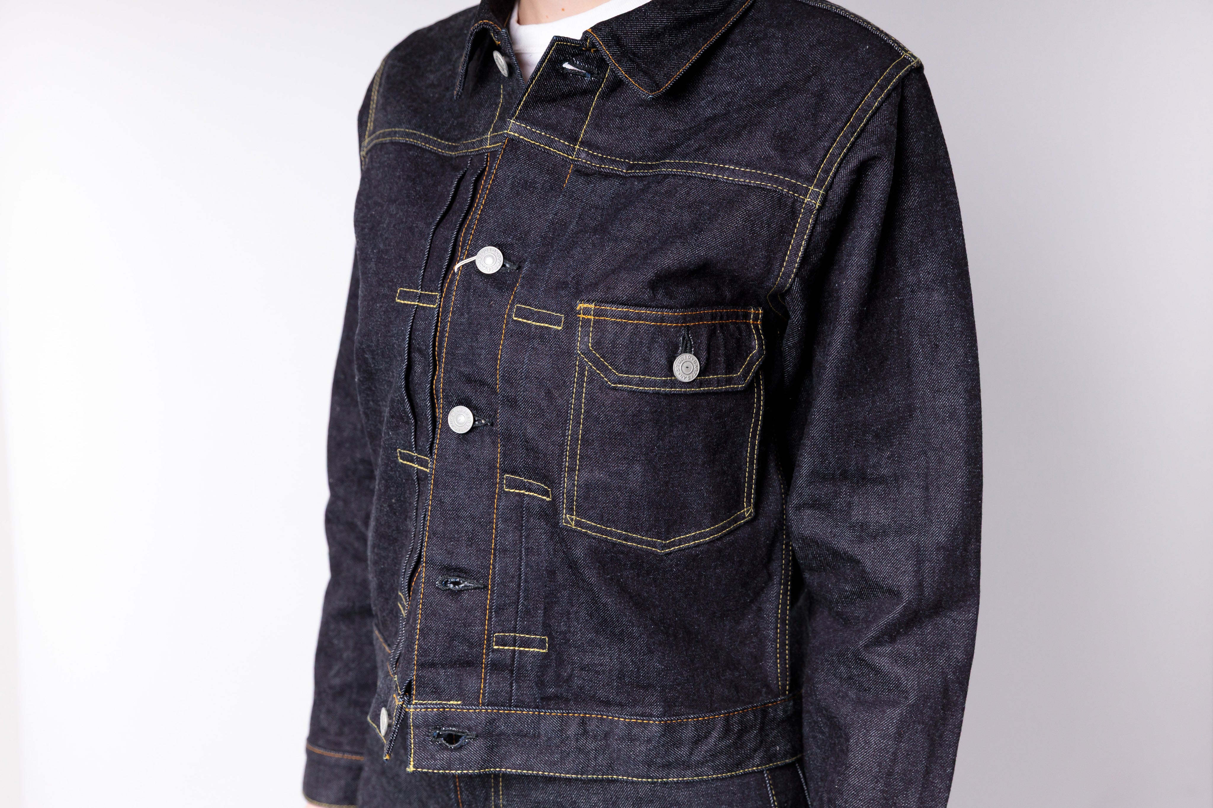 Dark denim jacket on a white background