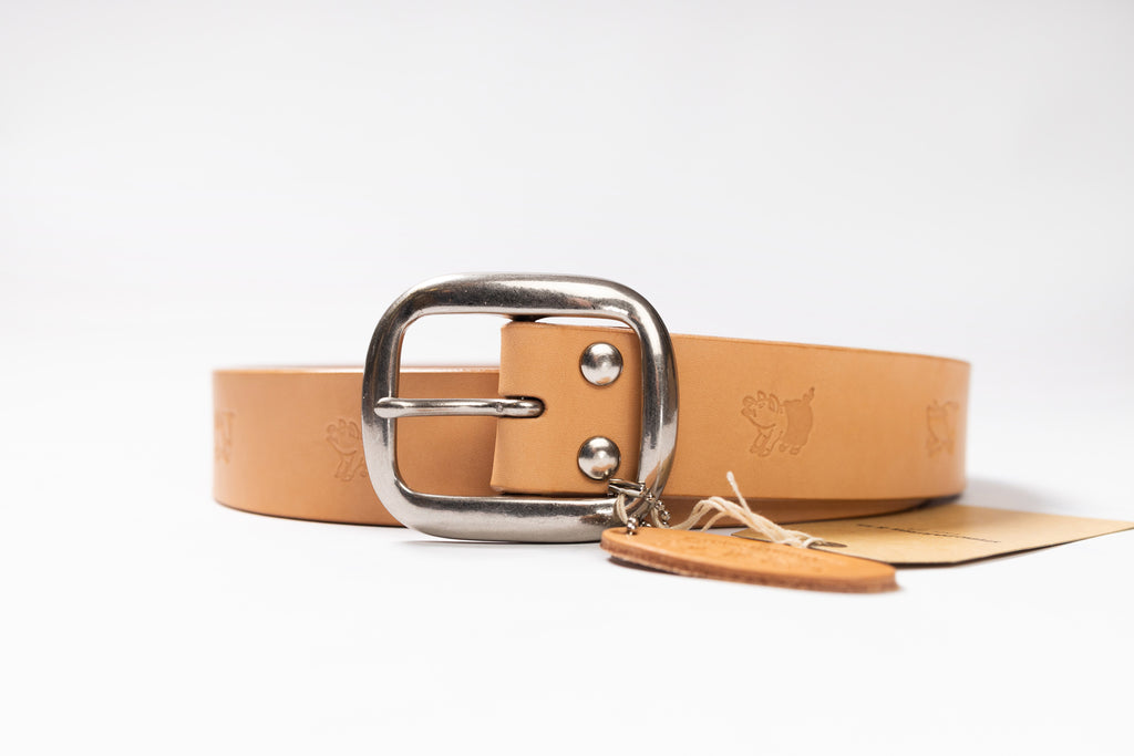 Tan leather belt with silver buckle on a white background