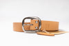 Tan leather belt with silver buckle on a white background