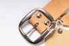 Close-up of a brown leather belt with a silver buckle on a white background
