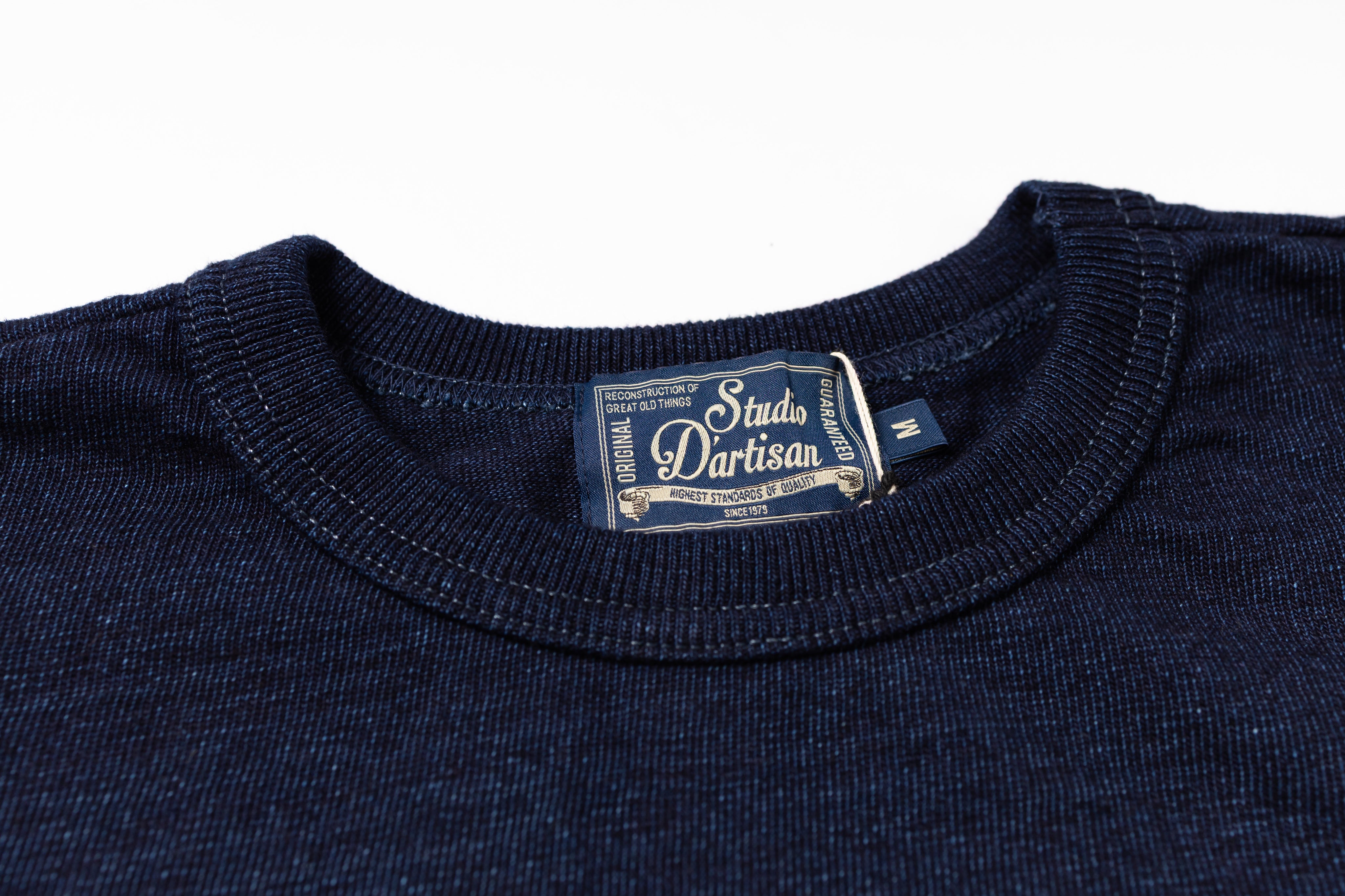 Navy blue shirt with a visible label on a white background