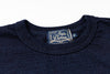 Navy blue shirt with a visible label on a white background