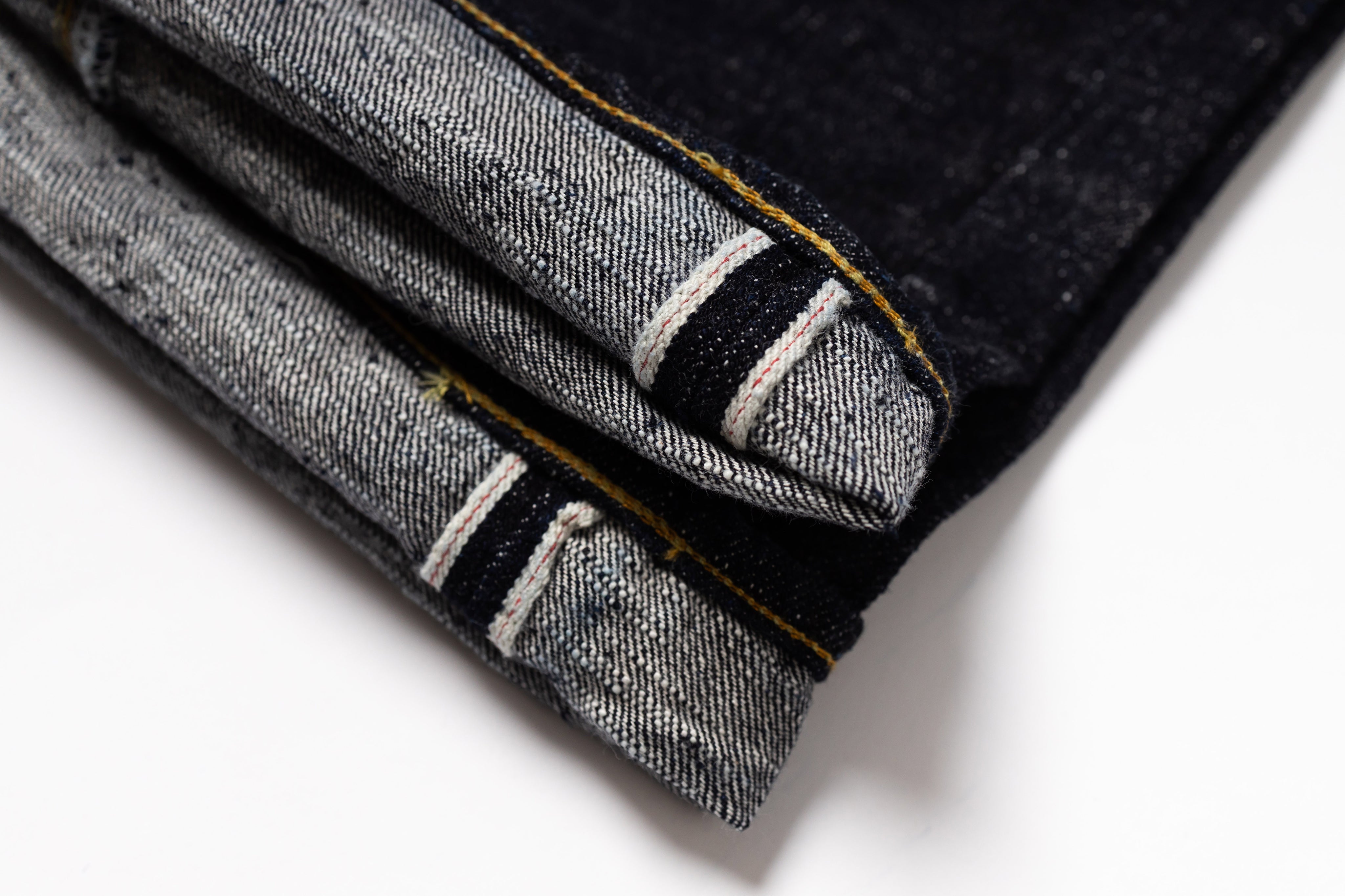 Close-up of folded denim fabric on a white background