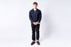 Man wearing a denim jacket and jeans on a white background