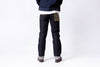 Person wearing dark blue jeans with a white background