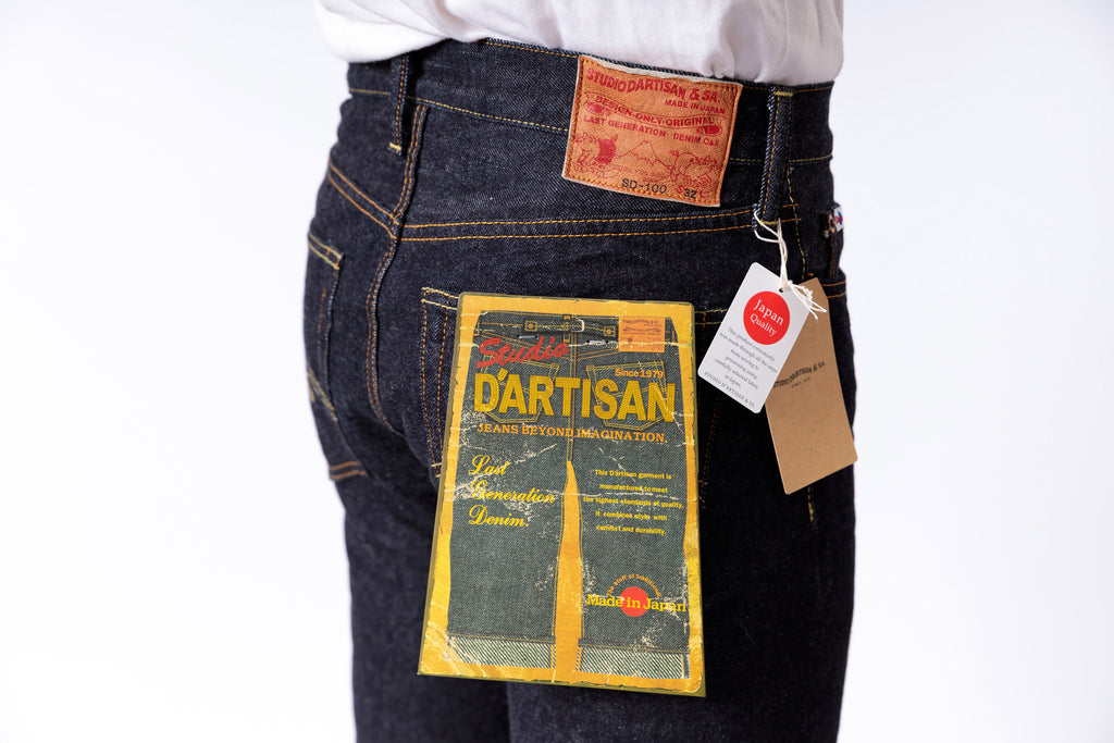 Dark blue jeans with a visible brand label on a white background