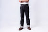 Person wearing dark jeans and brown boots on a white background