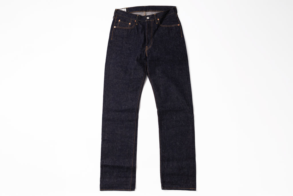 A pair of dark indigo straight-leg denim jeans laid flat against a solid white background.
