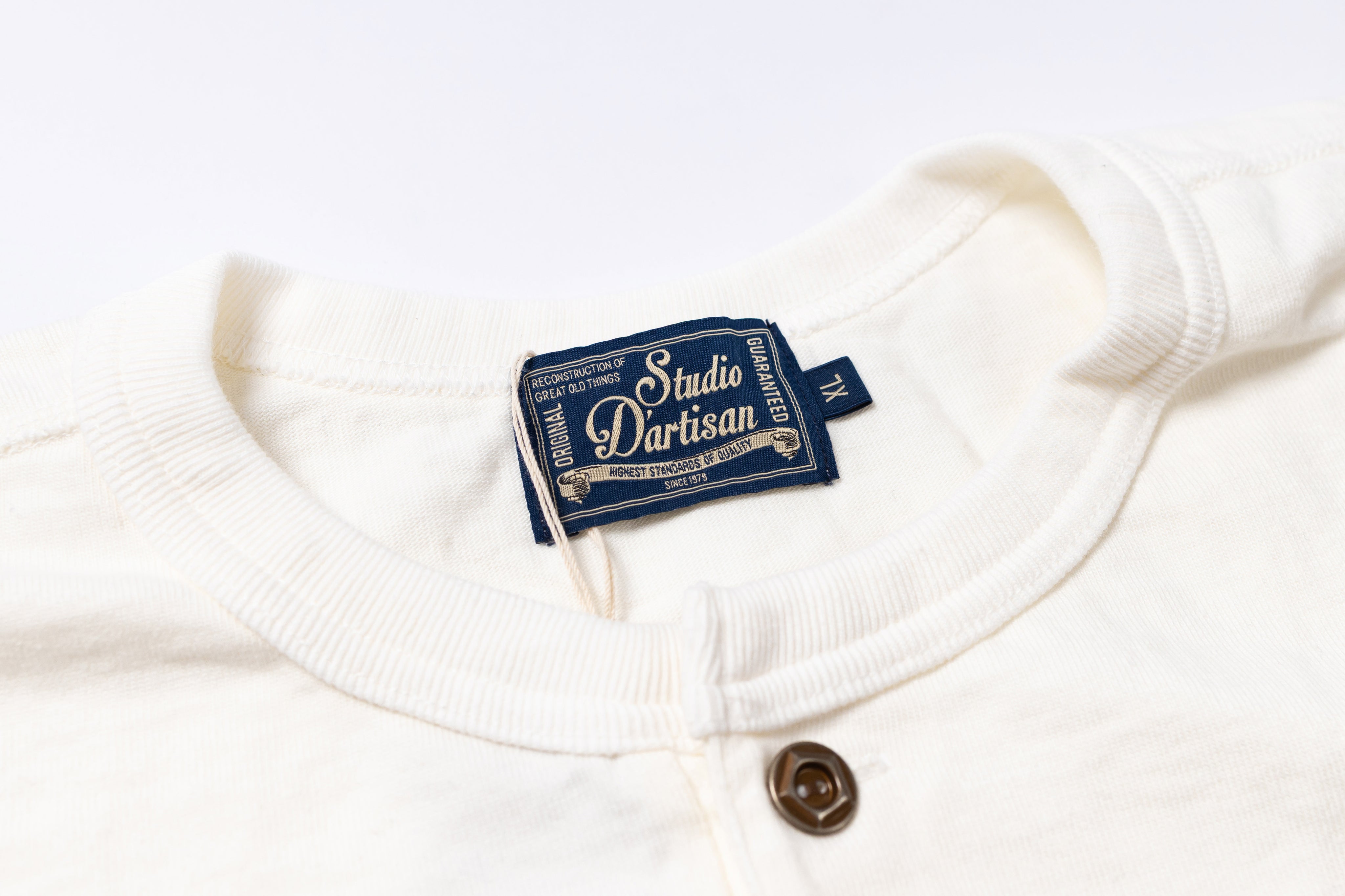 White garment with a blue label on a white background