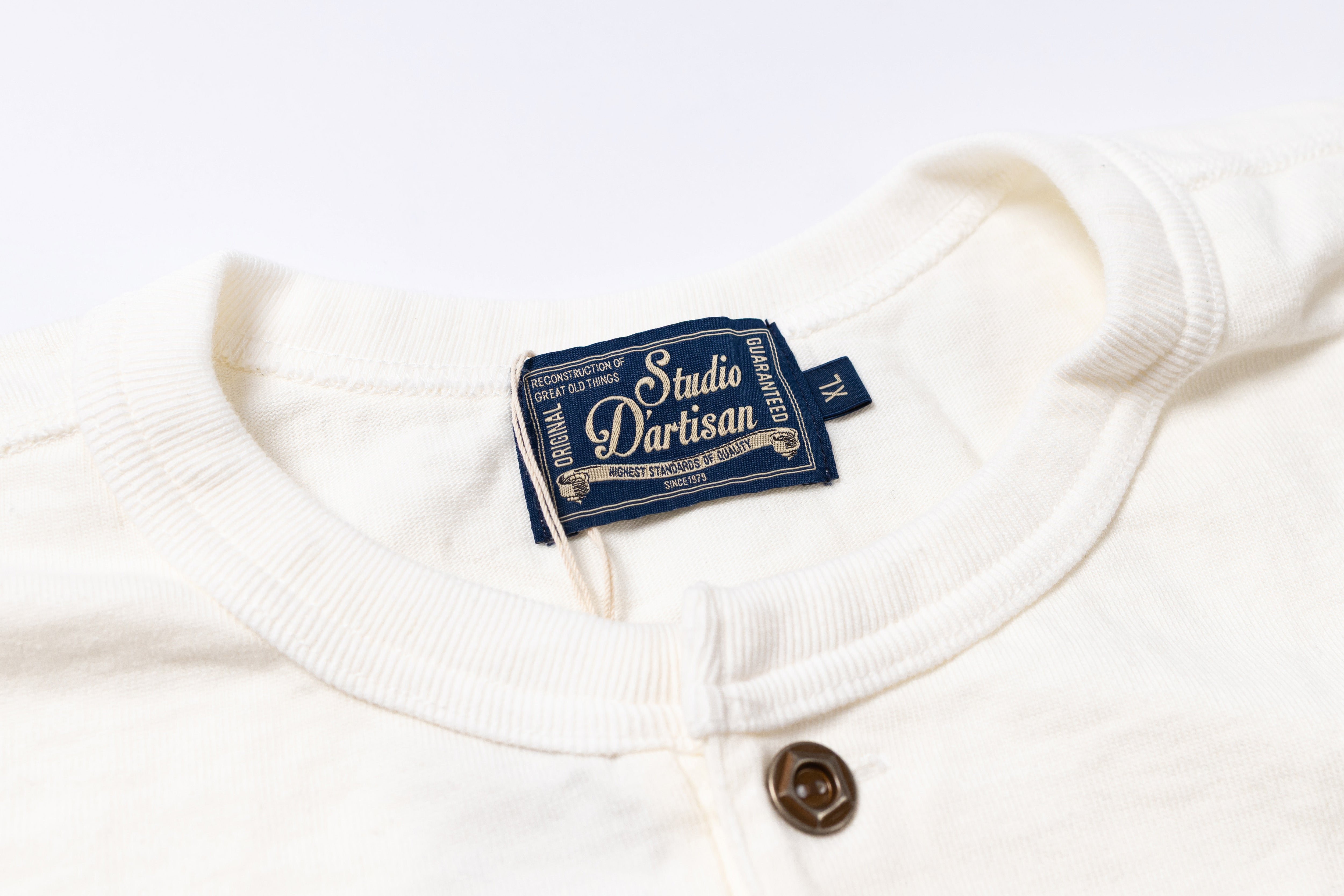 White garment with a blue label on a white background