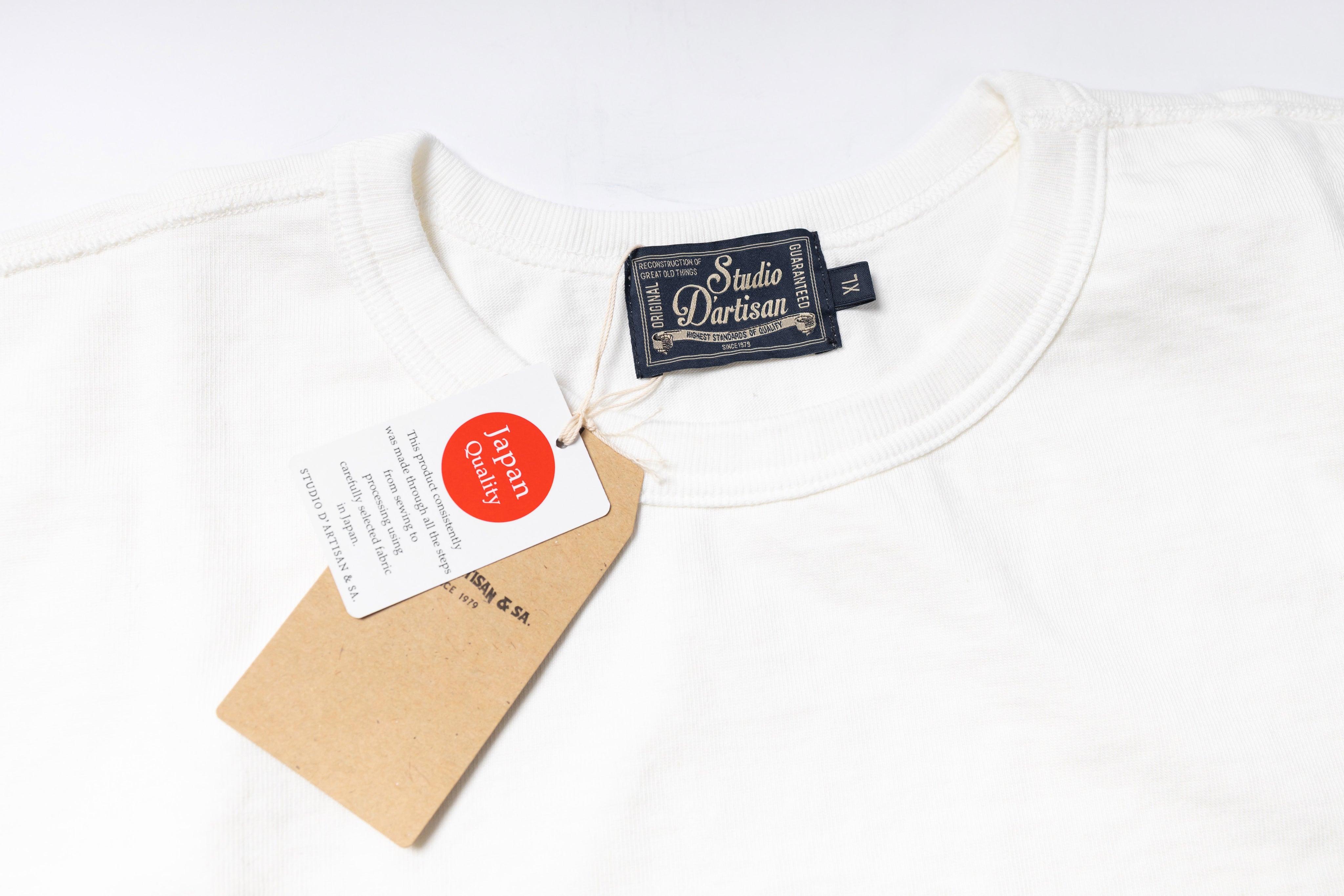 White t-shirt with a brand tag on a white background