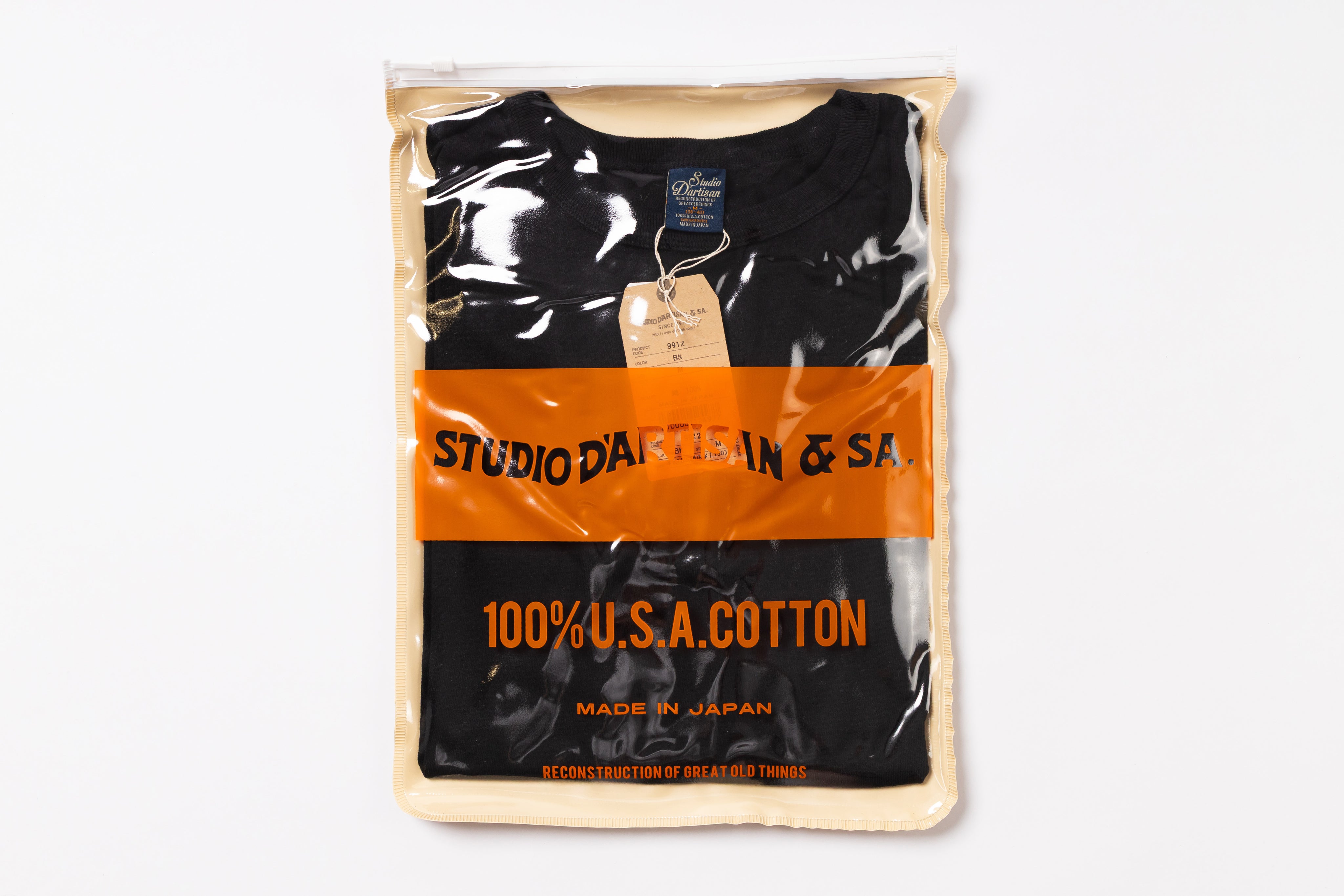Packaged black t-shirt with orange label on a white background