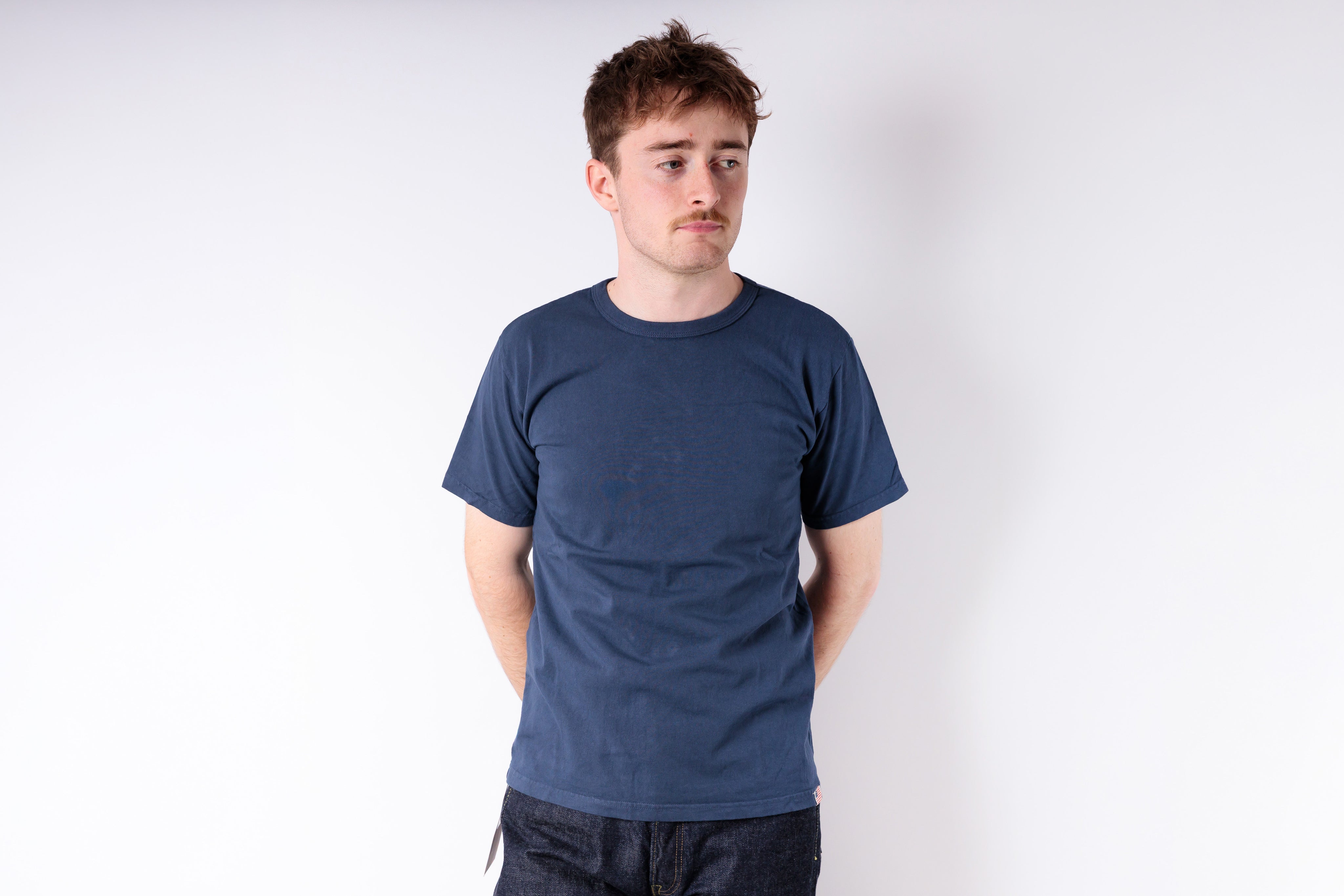 Man wearing a blue t-shirt against a white background