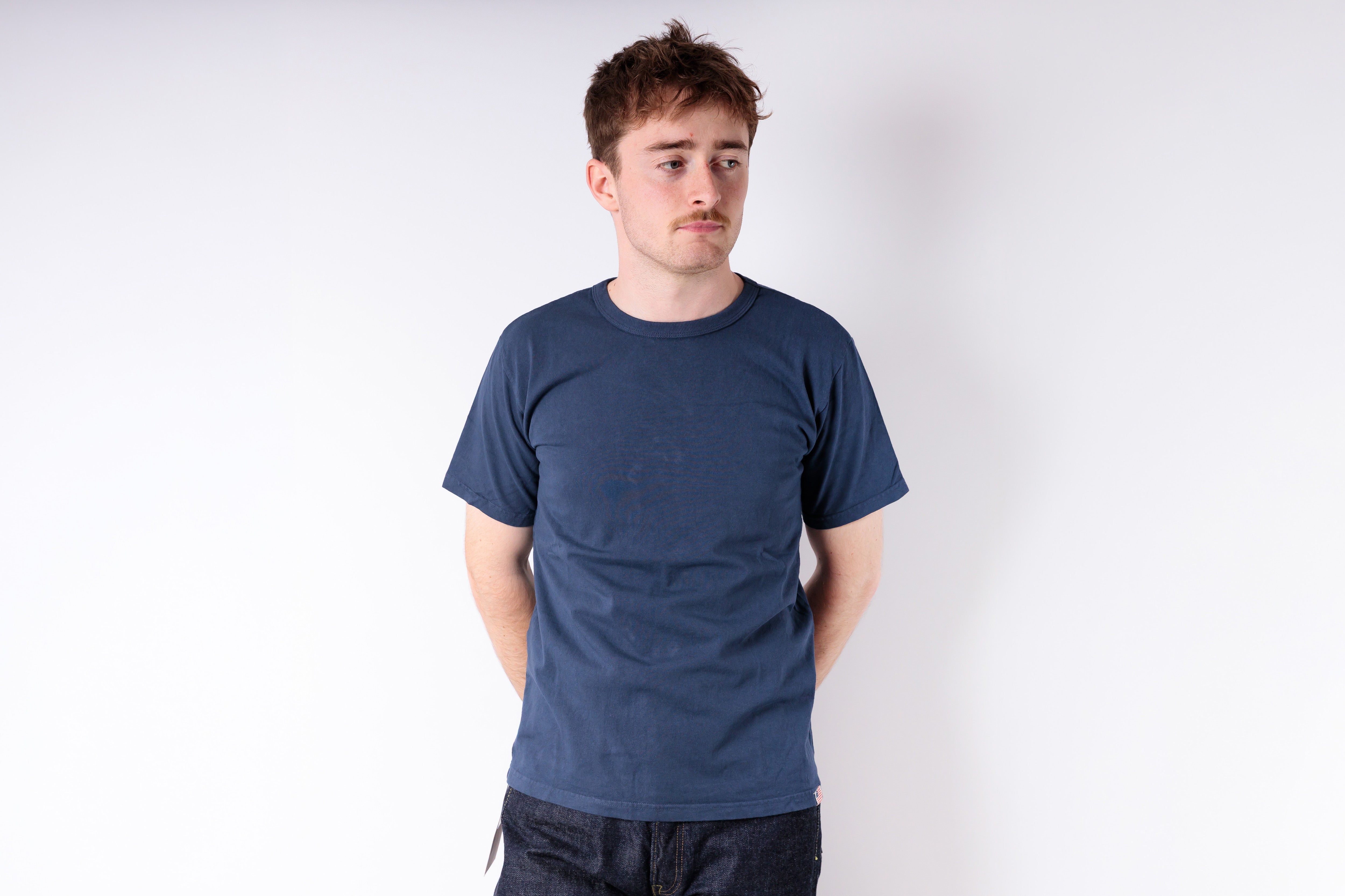 Man wearing a blue t-shirt against a white background