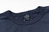Navy blue t-shirt with a brand label on a white background