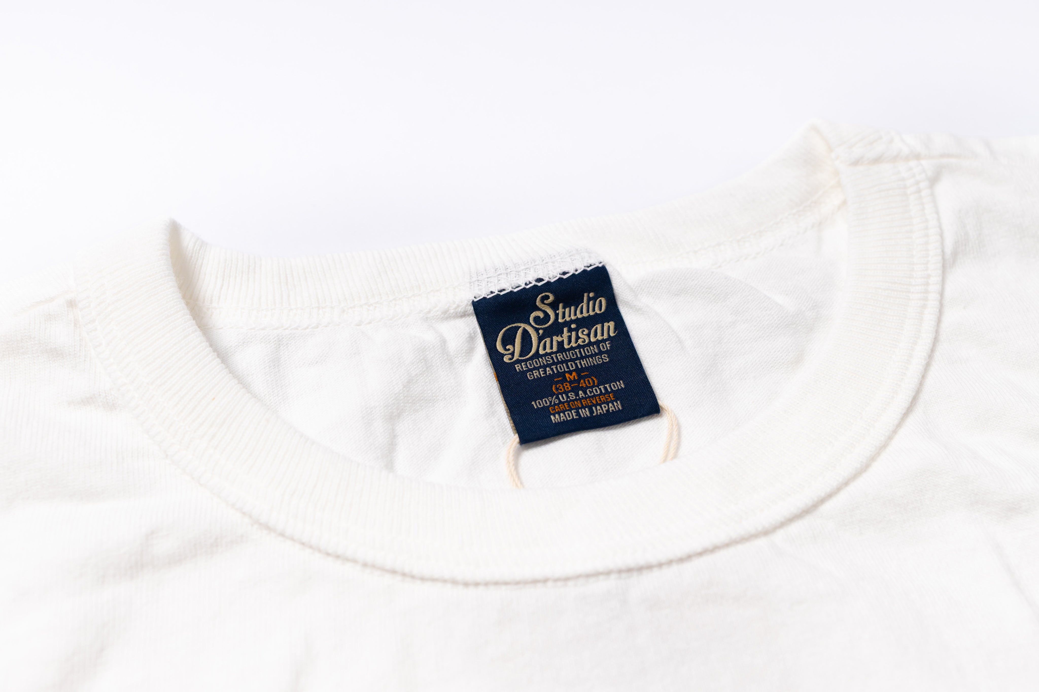 White t-shirt with a visible brand label on a white background