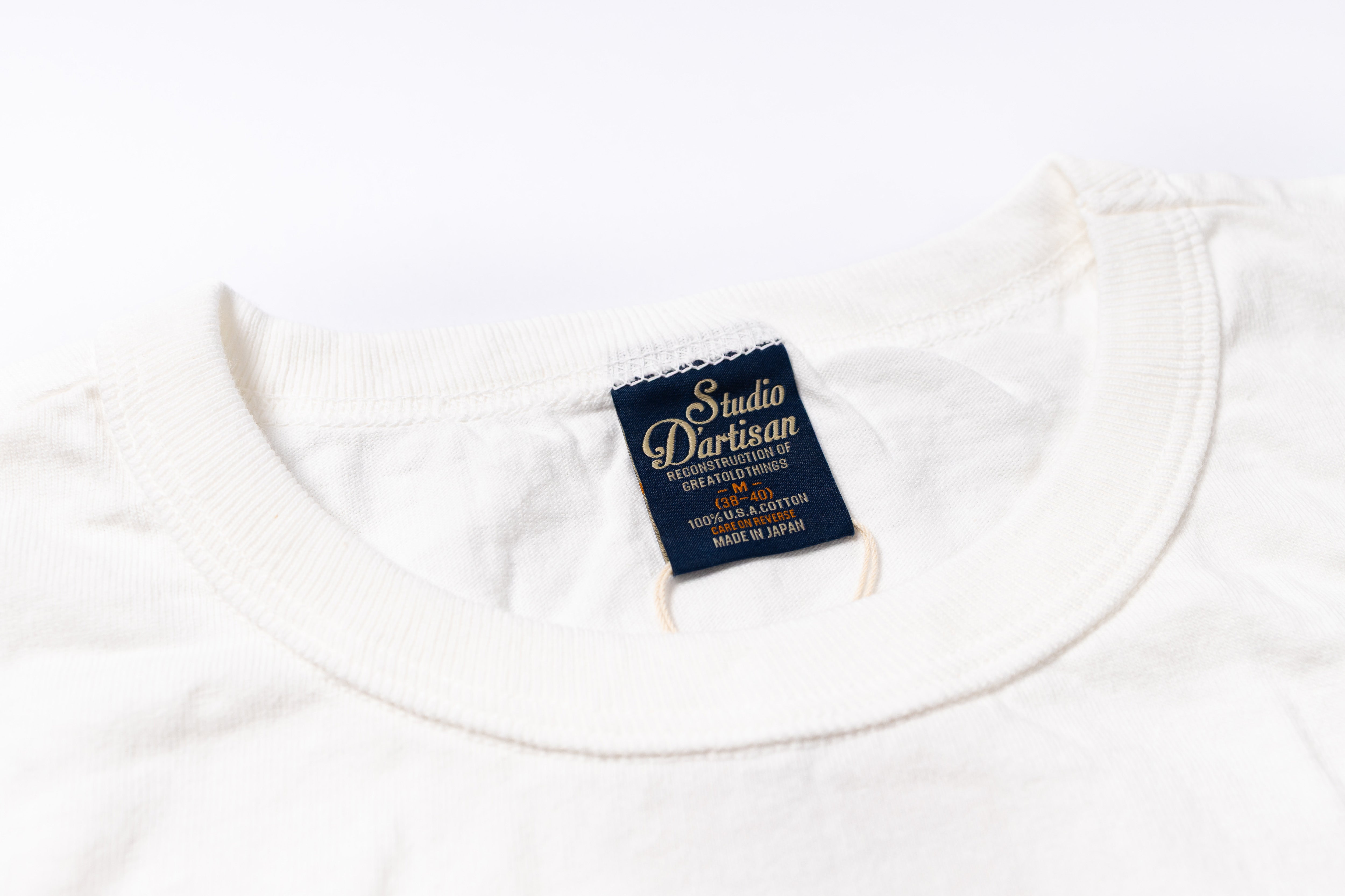 White t-shirt with a visible brand label on a white background