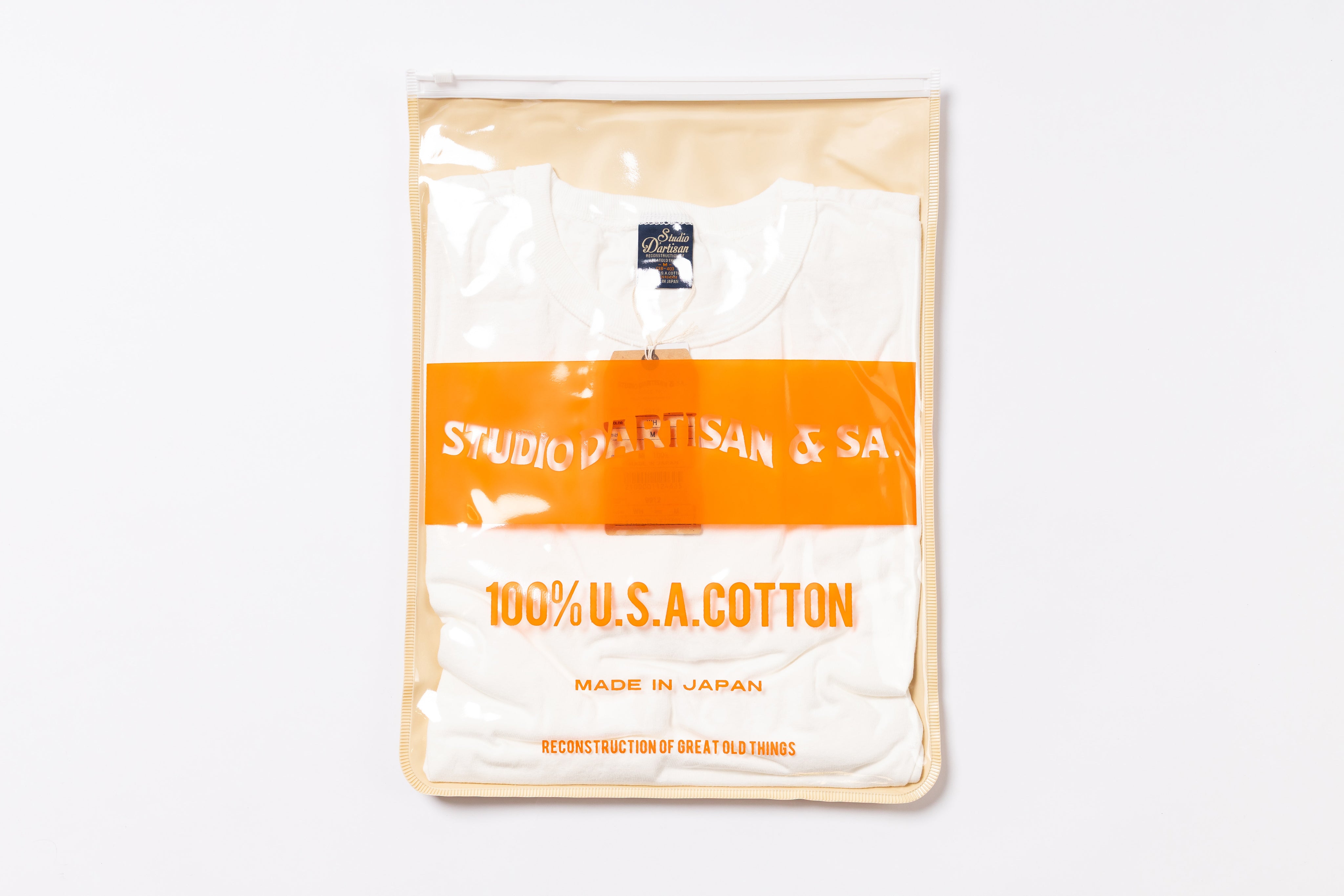 Packaged white t-shirt with orange label on a white background