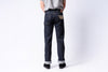 Person wearing dark blue jeans on a white background