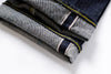 Folded denim jeans with a white background