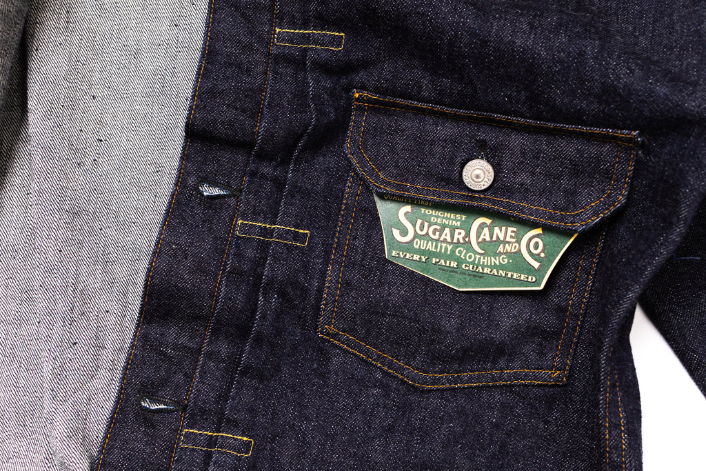 Denim jacket with a visible brand label on a white background