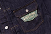 Close-up of a denim jacket pocket with a visible brand label.