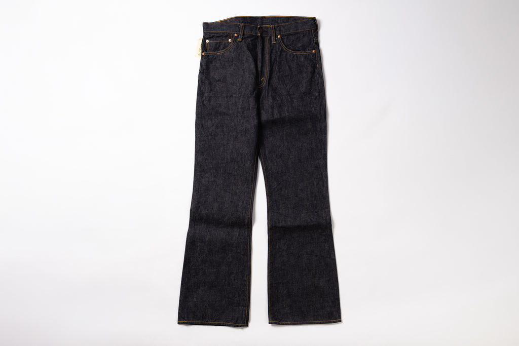 A pair of dark indigo denim jeans with a straight-to-flare leg, laid flat against a clean white background.