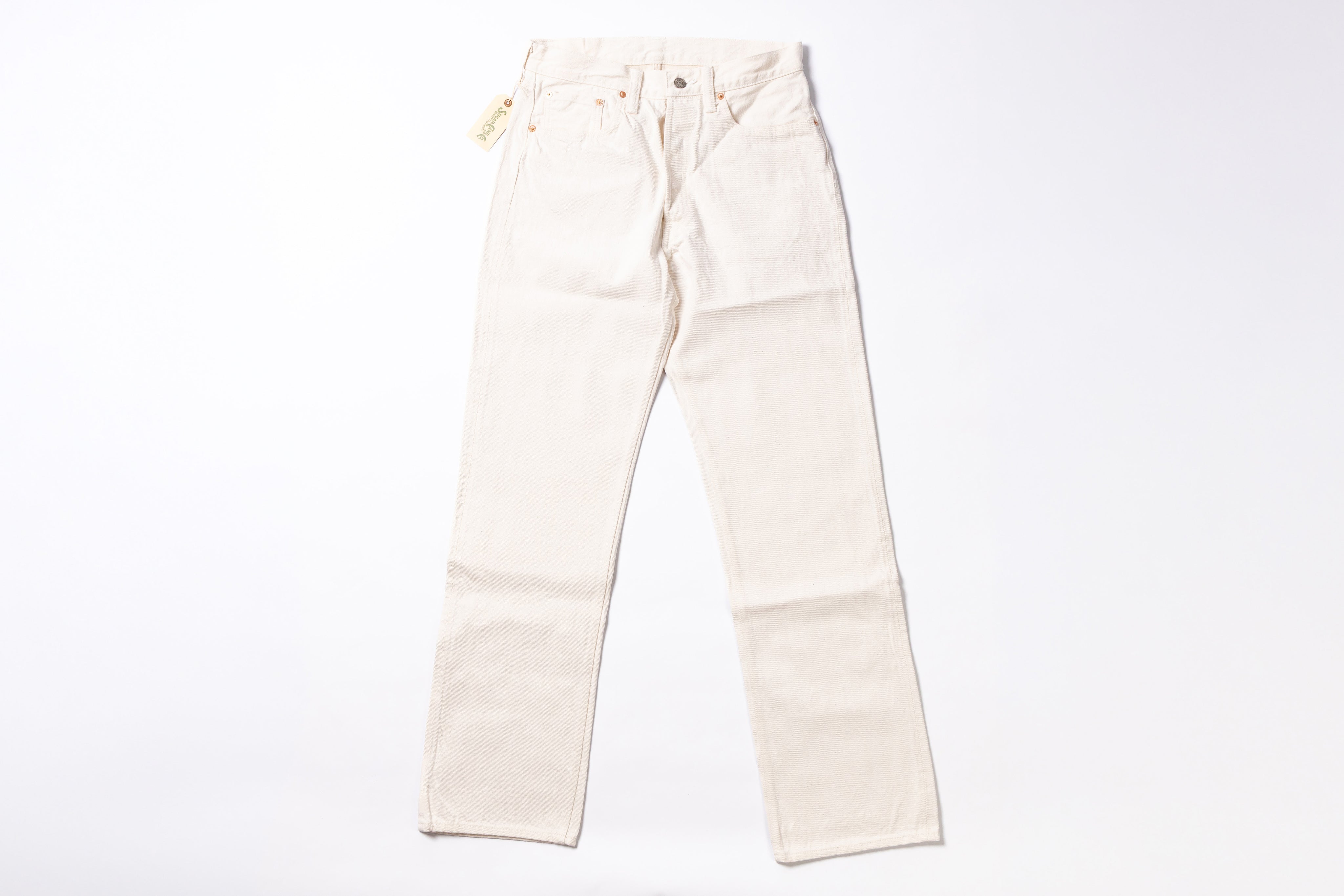 A pair of off-white or cream-colored denim jeans laid flat against a solid white background.
