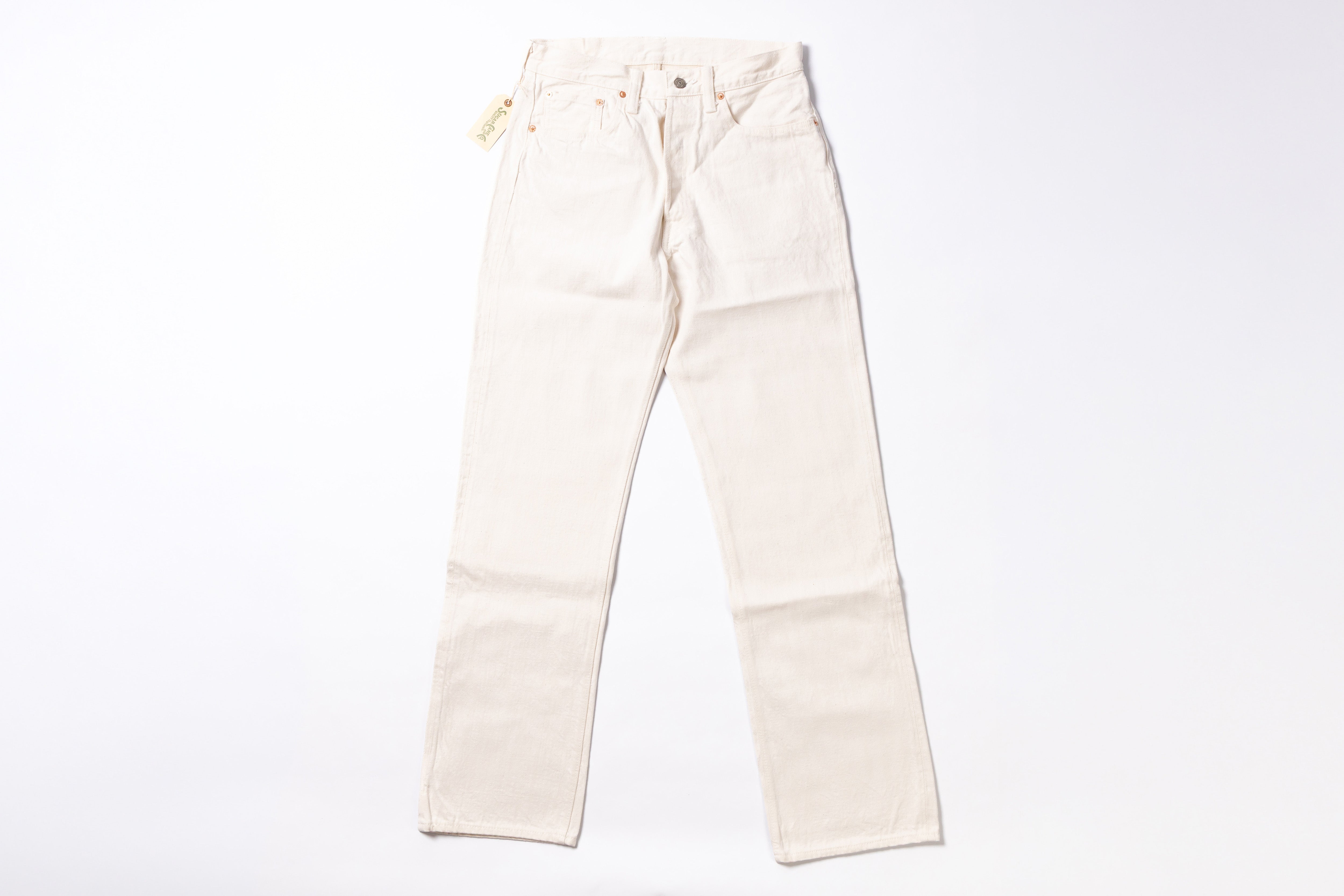 A pair of off-white or cream-colored denim jeans laid flat against a solid white background.
