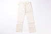 A pair of off-white or cream-colored denim jeans laid flat against a solid white background.