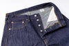 Close-up of a pair of blue jeans with a focus on the button and stitching details.