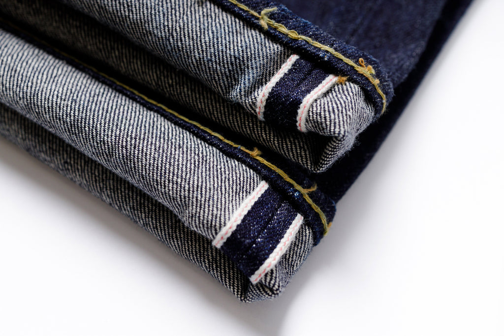 Rolled-up denim jeans with a white background
