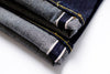 Rolled-up denim jeans with a white background