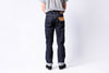 Person wearing dark blue jeans on a white background