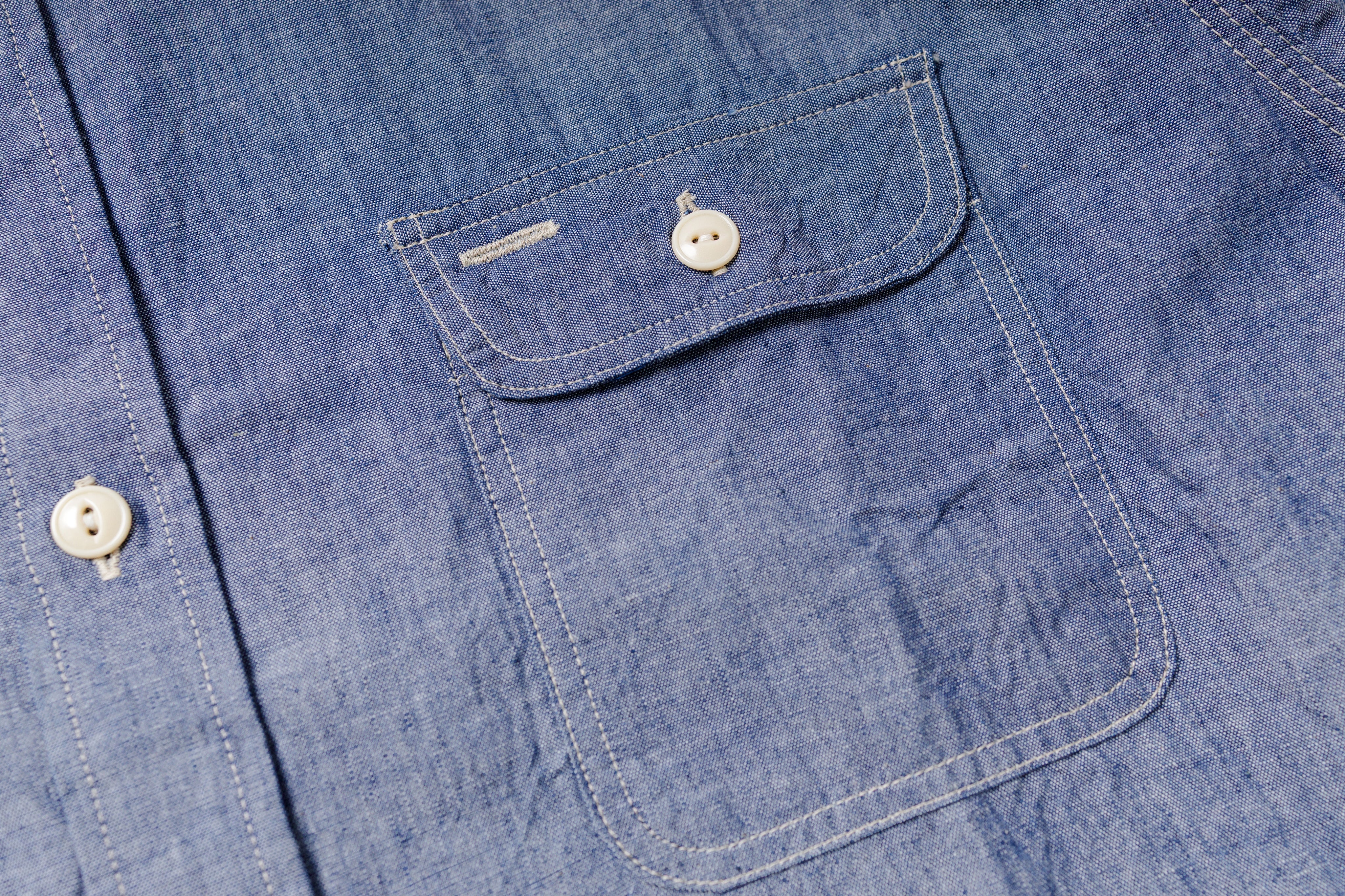 Close-up of a blue denim shirt with button details