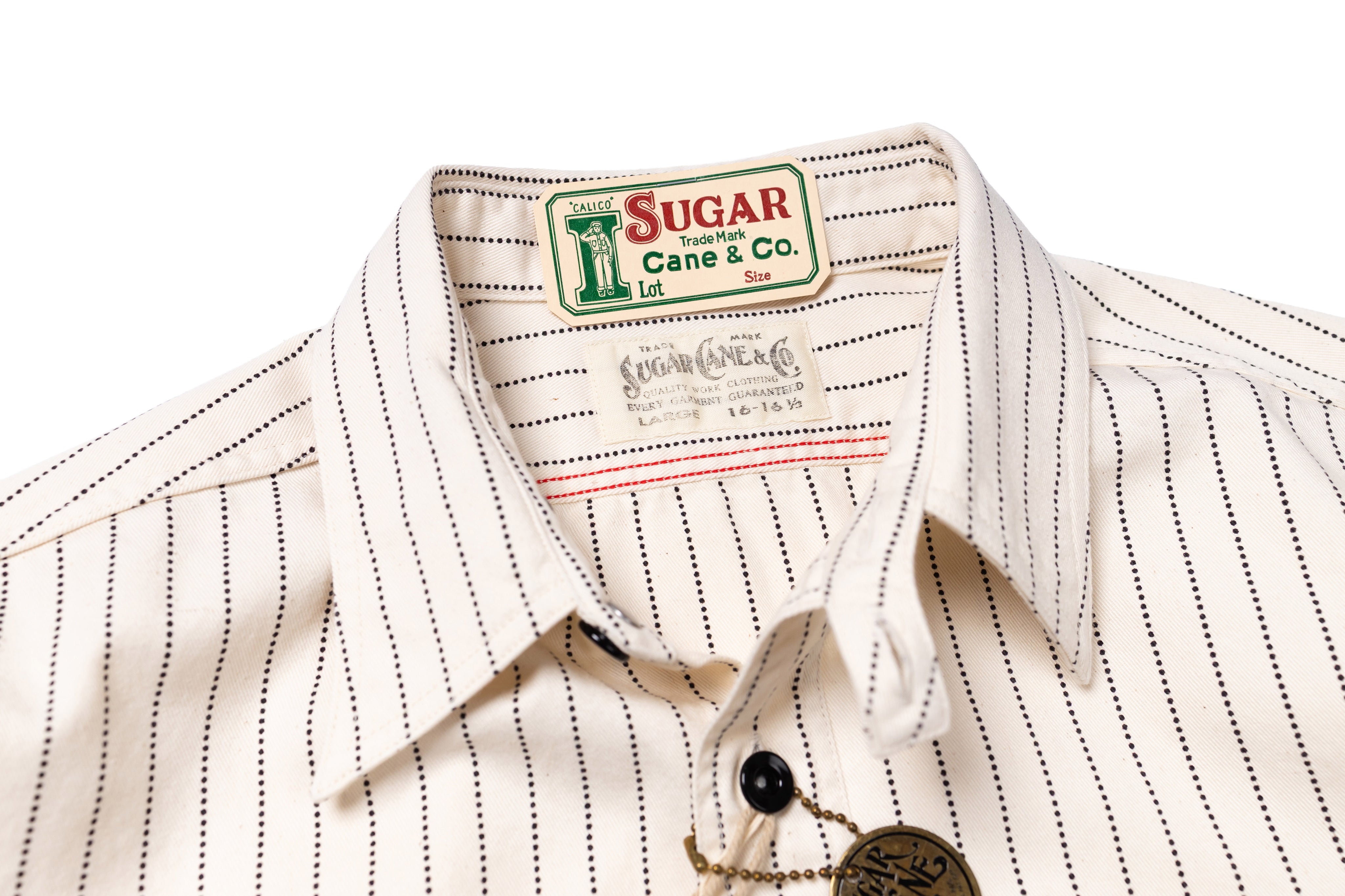 Close-up of a white shirt with black pinstripes and a visible brand label on a white background.