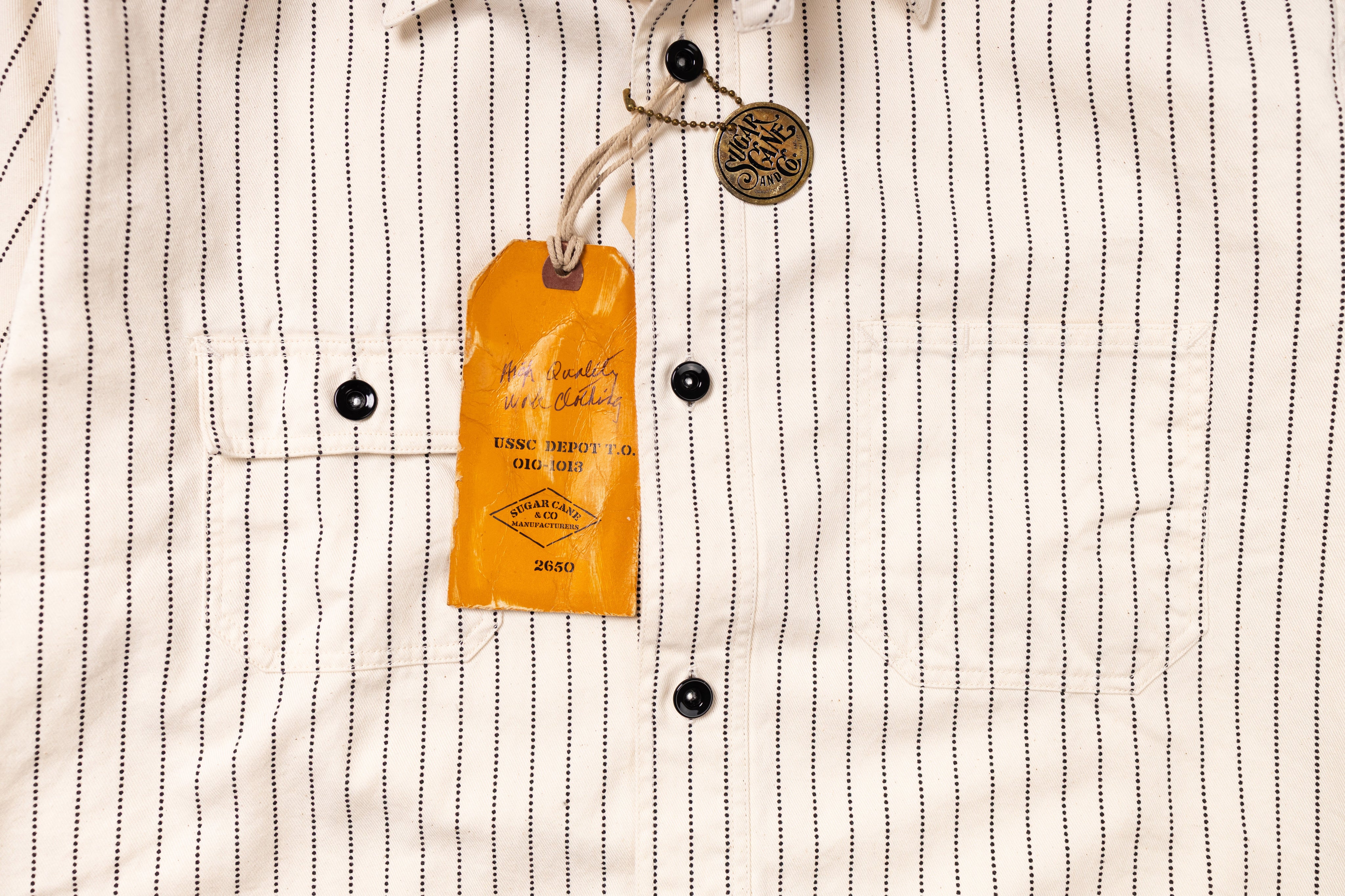 Close-up of a striped shirt with a brand tag on a white background