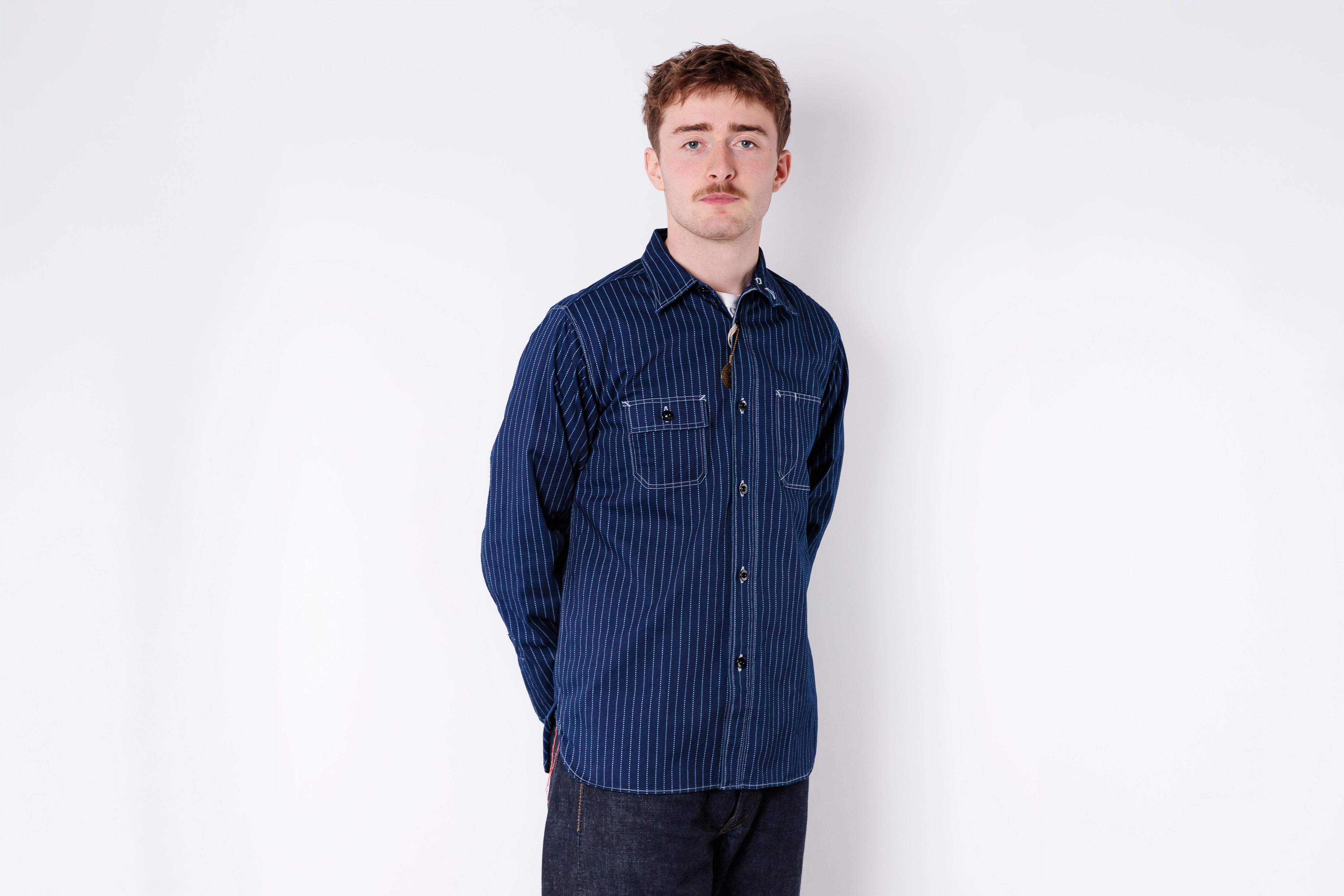 Man wearing a blue striped shirt against a white background