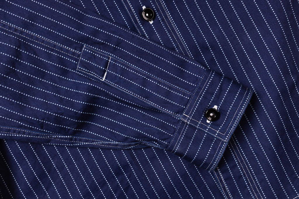 Close-up of a navy blue pinstripe shirt with button details