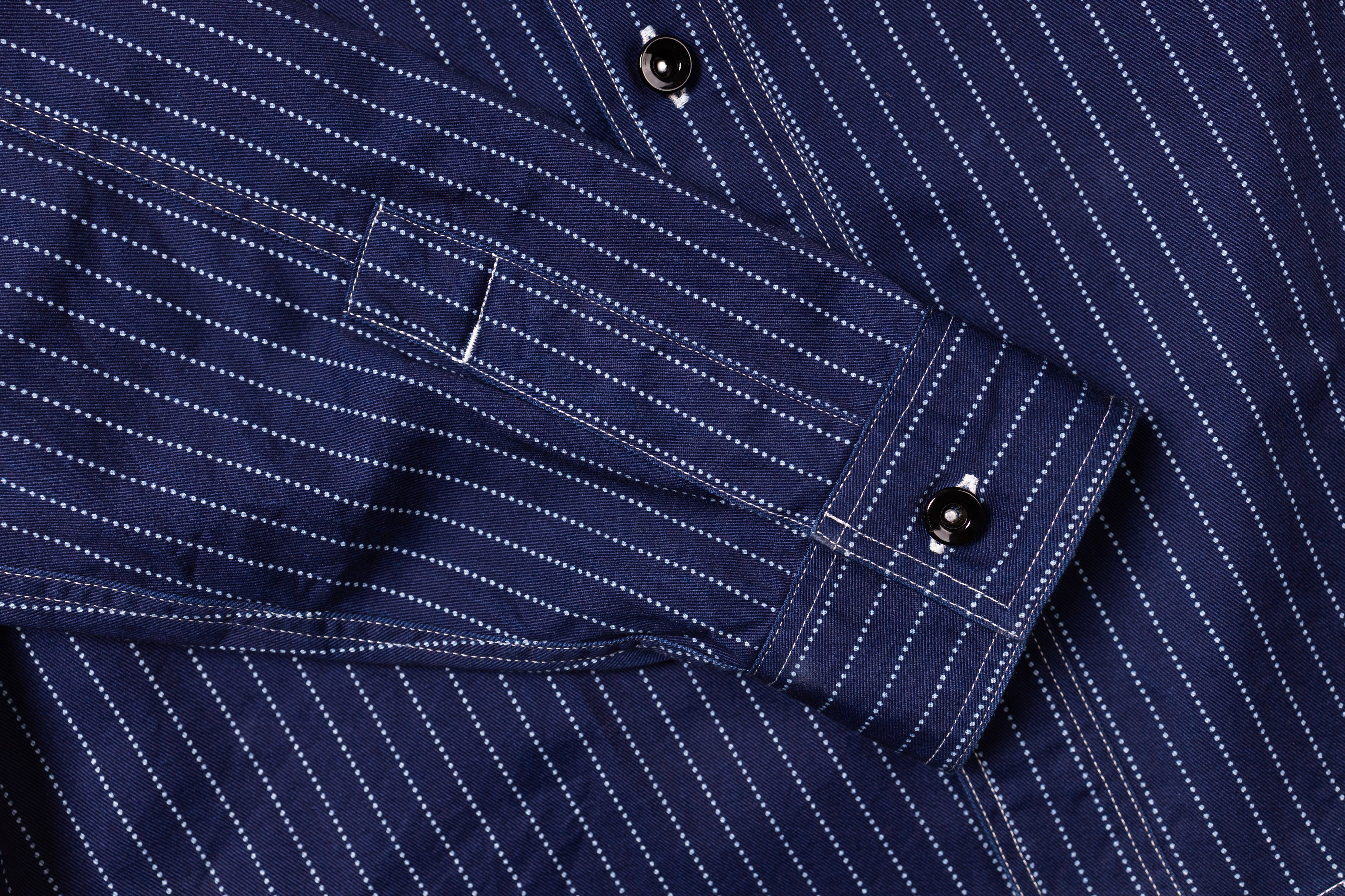 Close-up of a navy blue pinstripe shirt with button details