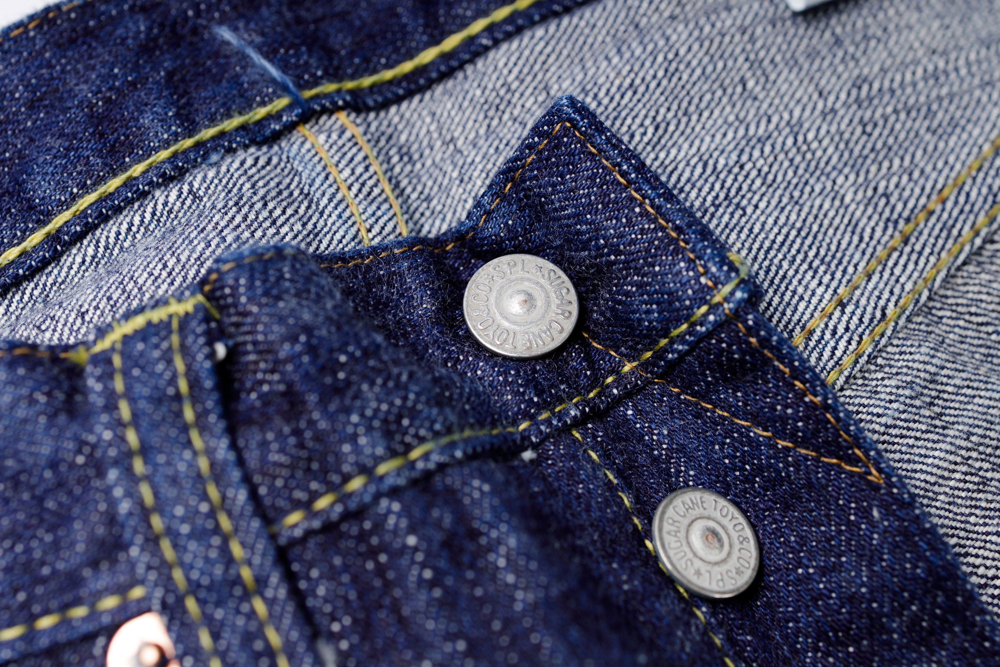 Close-up of a blue denim jacket with buttons